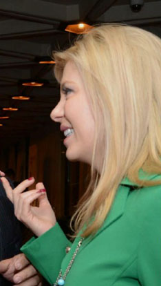 Eve Adams Eve Adams Piercing the monochromatic sea of suits, Adams favours brigth colours, chunky accessories and eye-catching bling in her haute-style collection. (photo and caption courtesy of Elizabeth Gray-Smith, iPolitics.ca)